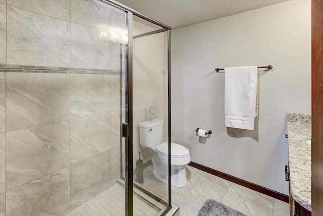 full bathroom featuring toilet, baseboards, and a stall shower