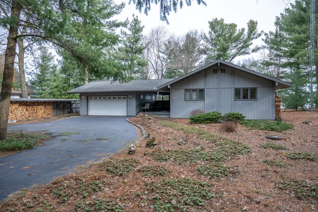 ranch-style home featuring driveway and a garage
