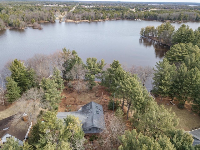 aerial view with a water view and a wooded view