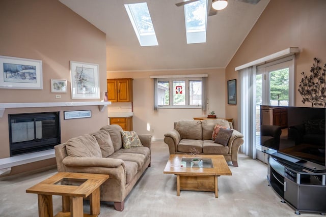 living area with light carpet, high vaulted ceiling, and a skylight