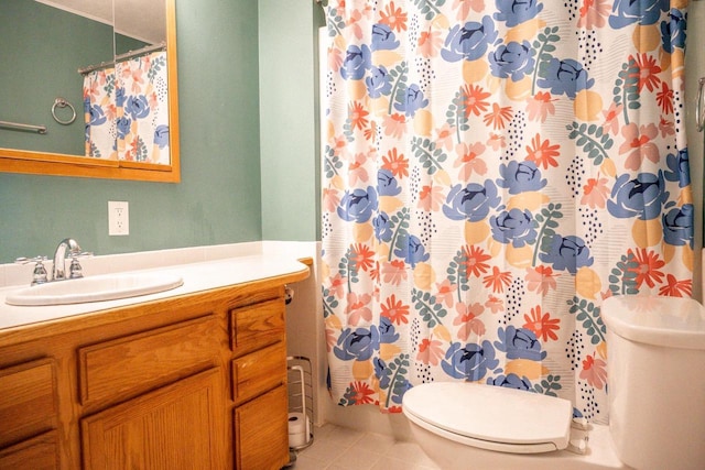 bathroom with toilet, curtained shower, tile patterned flooring, and vanity
