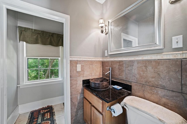 1941 S 124th St, New Berlin, WI 53151 - bathroom featuring toilet, vanity, wainscoting, and tile walls