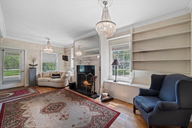 1941 S 124th St, New Berlin, WI 53151 - living room featuring ornamental molding, a chandelier, hardwood / wood-style flooring, and a fireplace