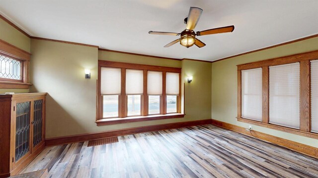 unfurnished living room featuring baseboards, a ceiling fan, and wood finished floors