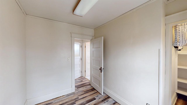 unfurnished room featuring light wood-type flooring and baseboards