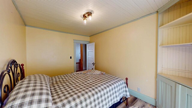bedroom with wood finished floors and baseboards