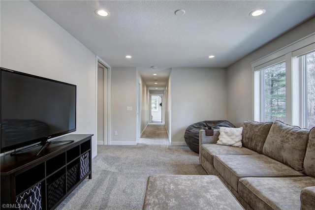 living room with light carpet, recessed lighting, plenty of natural light, and baseboards