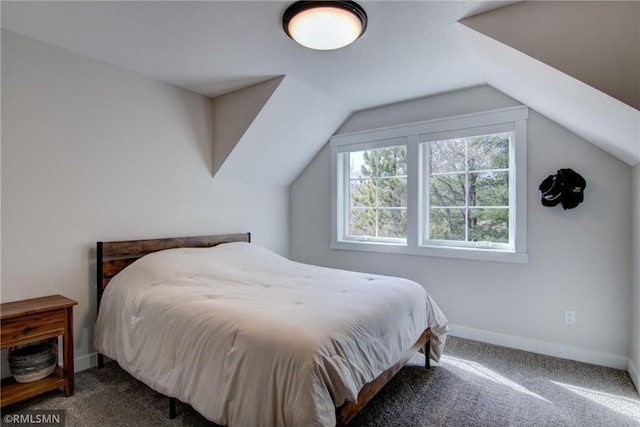 bedroom with carpet flooring, baseboards, and vaulted ceiling