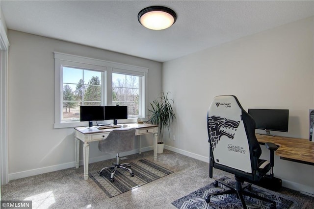 carpeted home office with baseboards