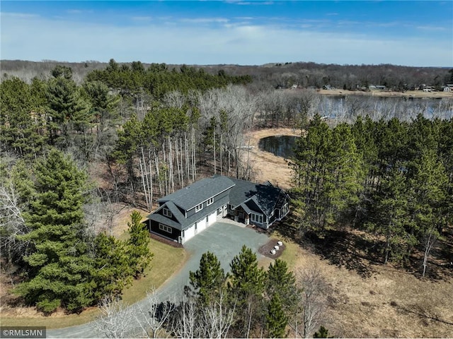 aerial view featuring a water view and a view of trees
