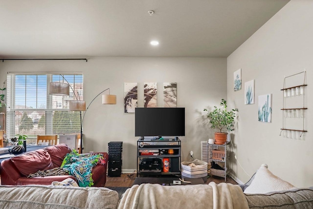 living room with wood finished floors, baseboards, and recessed lighting