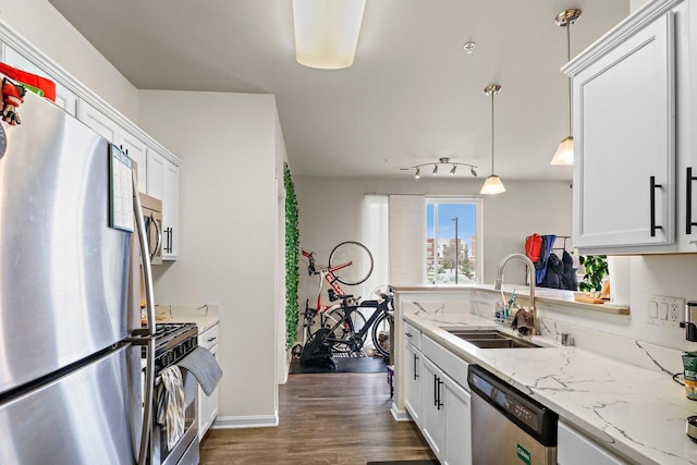 kitchen with dark wood-style flooring, a sink, white cabinetry, and stainless steel appliances