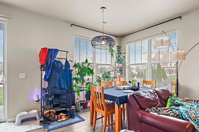 dining area featuring visible vents and wood finished floors