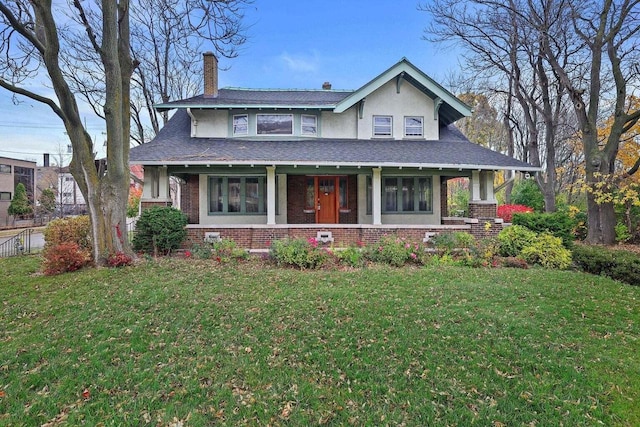 3316 W Wisconsin Ave, Milwaukee, WI 53208 - view of front of property featuring a chimney, a front lawn, and brick siding