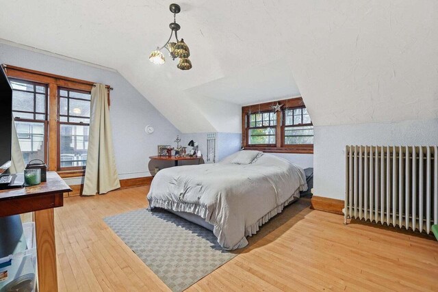 3316 W Wisconsin Ave, Milwaukee, WI 53208 - bedroom with light wood-type flooring, radiator, baseboards, and lofted ceiling