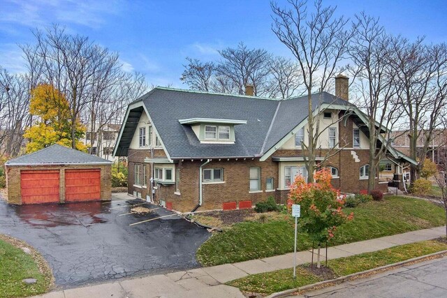 3316 W Wisconsin Ave, Milwaukee, WI 53208 - view of front of home featuring an outdoor structure, a chimney, brick siding, a garage, and a shingled roof