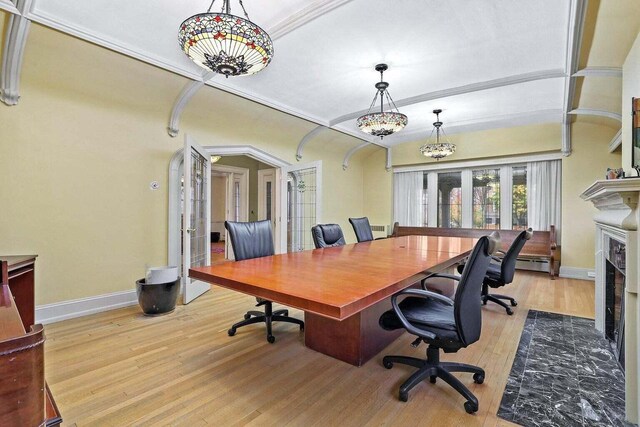 3316 W Wisconsin Ave, Milwaukee, WI 53208 - home office with baseboards, a baseboard radiator, light wood finished floors, a fireplace with flush hearth, and french doors