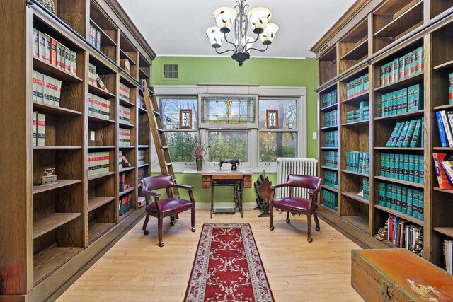 3316 W Wisconsin Ave, Milwaukee, WI 53208 - sitting room with visible vents, radiator, a chandelier, and wood finished floors