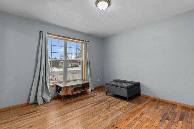 interior space with wood-type flooring and baseboards