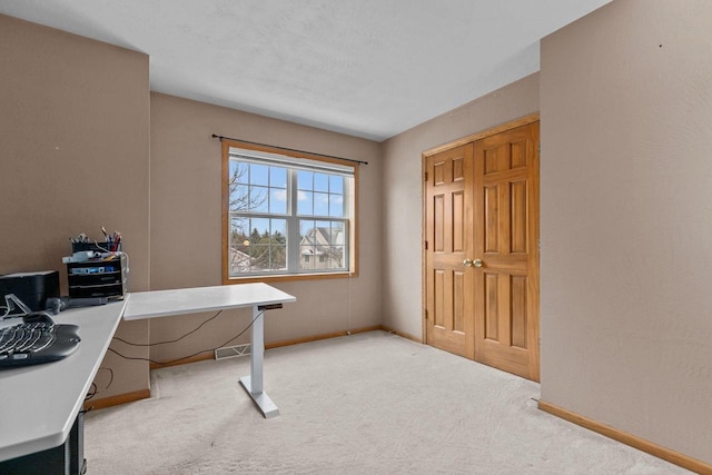 office space with light carpet and baseboards