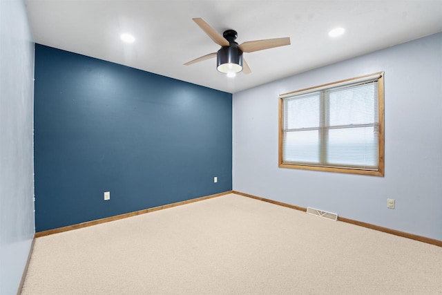 carpeted empty room featuring recessed lighting, visible vents, baseboards, and ceiling fan