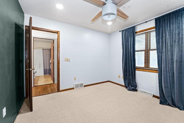 unfurnished bedroom featuring visible vents, baseboards, a ceiling fan, and carpet