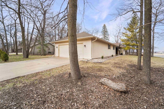 view of home's exterior featuring a garage and concrete driveway