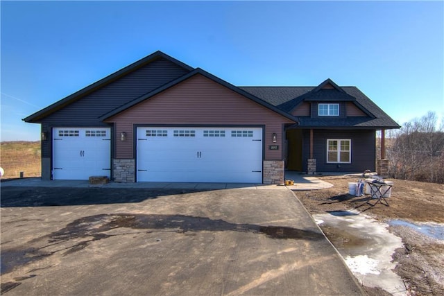 E5215 Queens Dr, Eleva, WI 54738 - craftsman-style home featuring stone siding, a garage, and concrete driveway