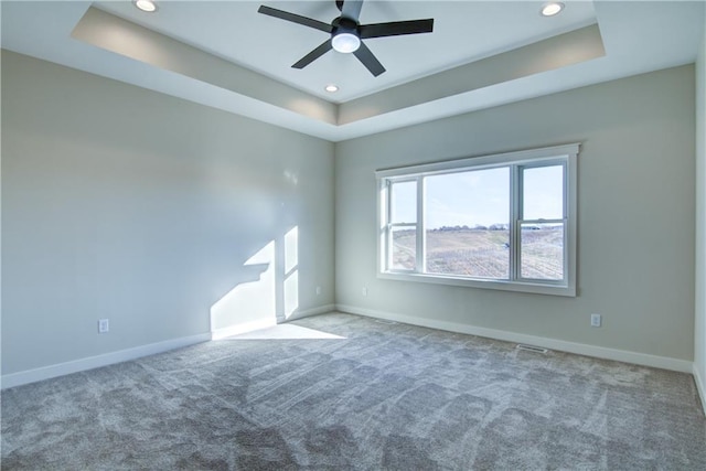 E5215 Queens Dr, Eleva, WI 54738 - carpeted empty room featuring a raised ceiling, ceiling fan, baseboards, and recessed lighting
