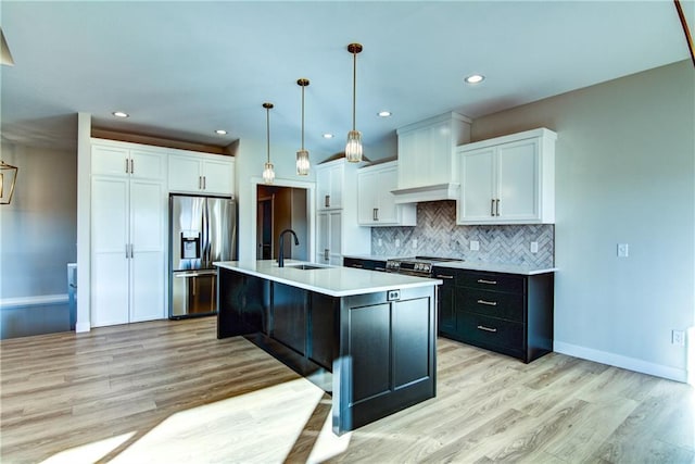 E5215 Queens Dr, Eleva, WI 54738 - kitchen with stainless steel appliances, a sink, white cabinetry, light countertops, and light wood-style floors