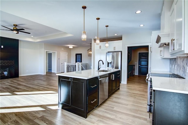 E5215 Queens Dr, Eleva, WI 54738 - kitchen with appliances with stainless steel finishes, ceiling fan, light countertops, light wood-style floors, and recessed lighting