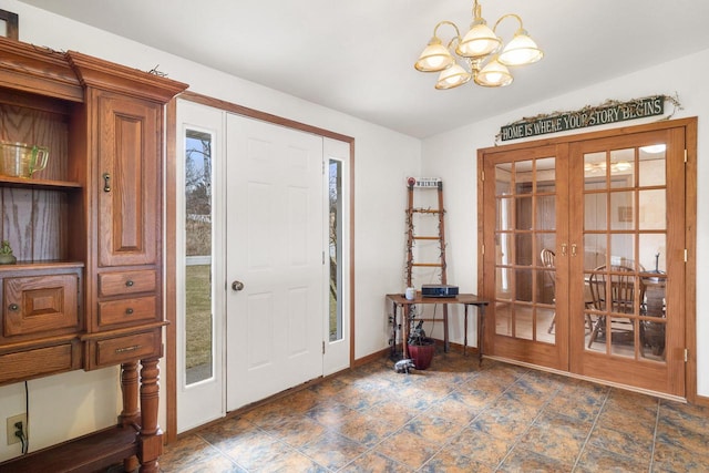 entrance foyer featuring french doors, baseboards, a chandelier, and vaulted ceiling
