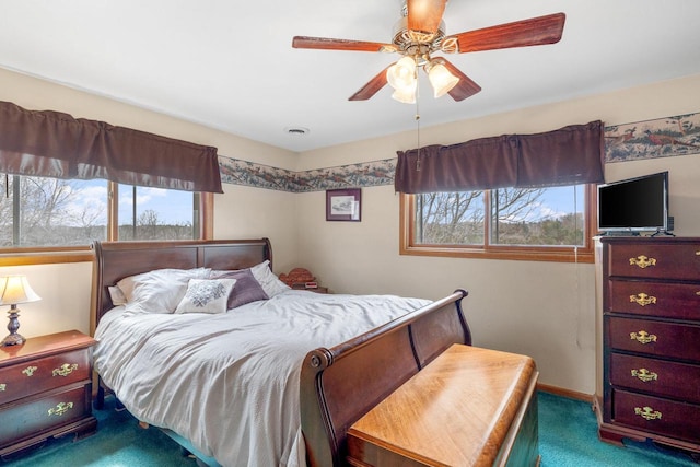 bedroom with visible vents, baseboards, multiple windows, and carpet flooring