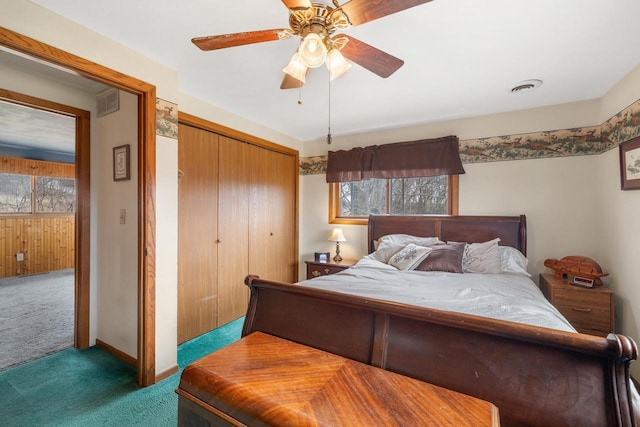 bedroom with a closet, visible vents, a ceiling fan, and carpet