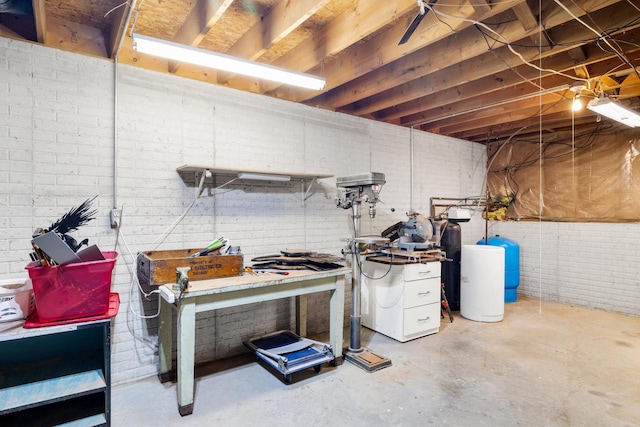 unfinished below grade area featuring brick wall and a workshop area