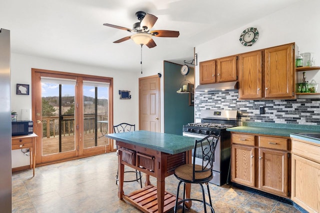 kitchen featuring tasteful backsplash, stainless steel gas range, black microwave, open shelves, and under cabinet range hood