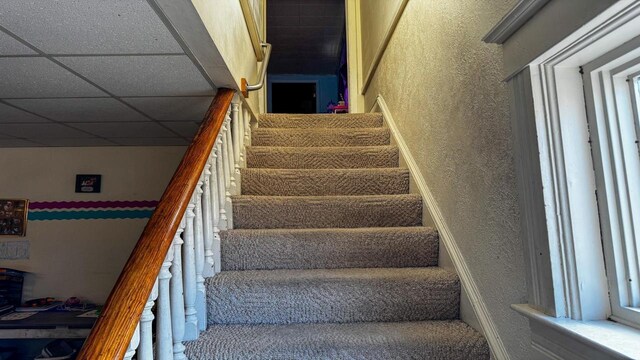 816 Royalton St, Waupaca, WI 54981 - stairway featuring a drop ceiling and a textured wall
