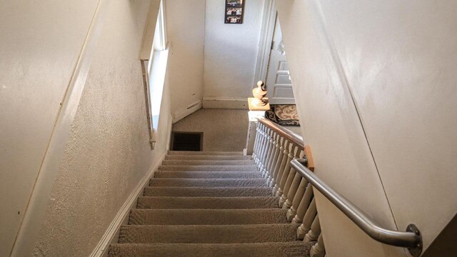 816 Royalton St, Waupaca, WI 54981 - stairway with a textured wall, carpet, and visible vents