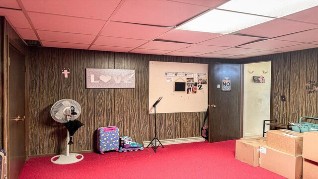 816 Royalton St, Waupaca, WI 54981 - interior space featuring wood walls, a drop ceiling, and carpet floors
