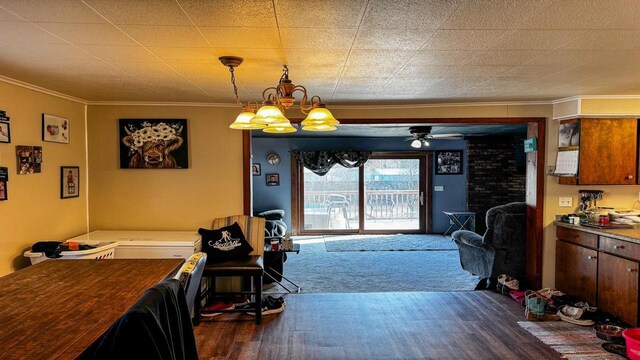 816 Royalton St, Waupaca, WI 54981 - dining area featuring crown molding, wood finished floors, and ceiling fan with notable chandelier