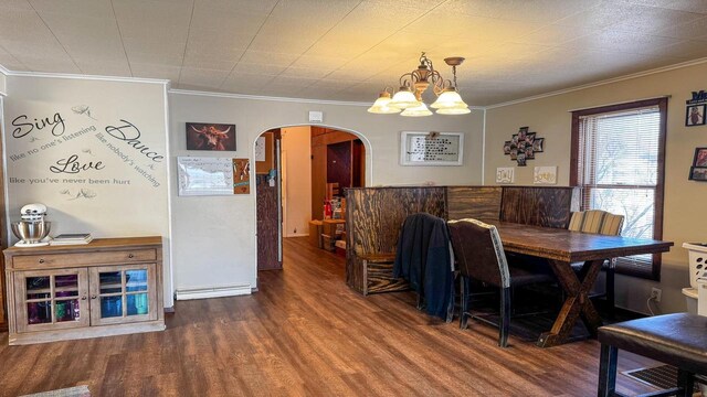 816 Royalton St, Waupaca, WI 54981 - dining room with crown molding, arched walkways, a notable chandelier, and wood finished floors