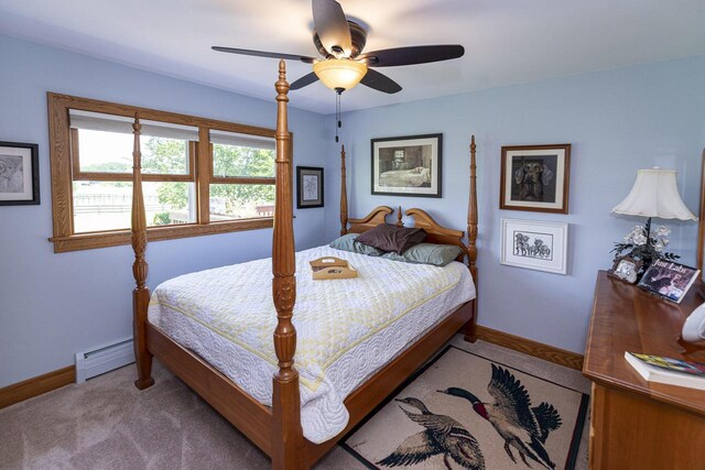 W340S2401 County Road C, Oconomowoc, WI 53066 - carpeted bedroom with a baseboard radiator, a ceiling fan, and baseboards