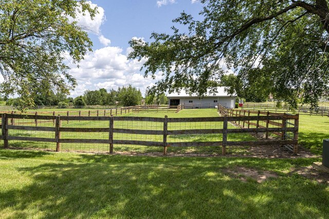 W340S2401 County Road C, Oconomowoc, WI 53066 - view of gate featuring an outbuilding, a lawn, and a rural view