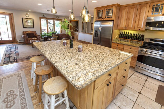 W340S2401 County Road C, Oconomowoc, WI 53066 - kitchen with open floor plan, a baseboard radiator, recessed lighting, stainless steel appliances, and light stone counters