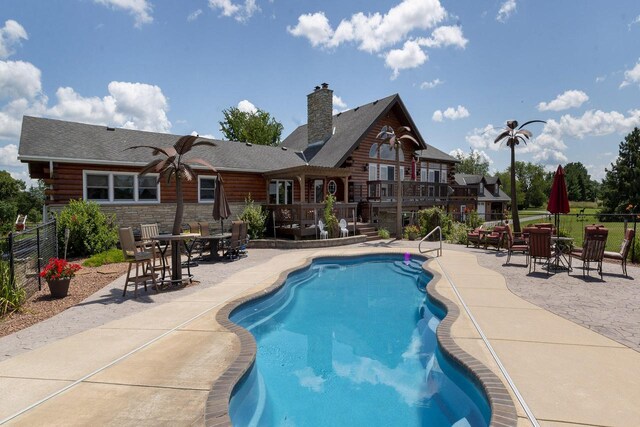 W340S2401 County Road C, Oconomowoc, WI 53066 - view of swimming pool featuring a fenced in pool, a patio area, a fenced backyard, and a deck