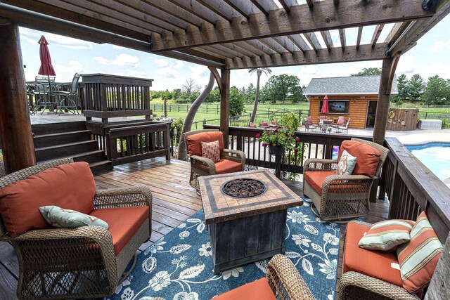 W340S2401 County Road C, Oconomowoc, WI 53066 - deck featuring an outdoor living space with a fire pit, an outbuilding, a pergola, and fence