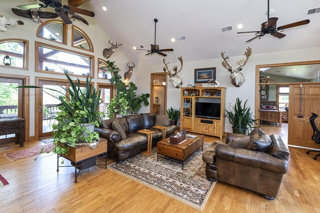 W340S2401 County Road C, Oconomowoc, WI 53066 - living room featuring high vaulted ceiling, visible vents, light wood-type flooring, and a ceiling fan