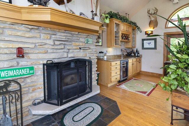 W340S2401 County Road C, Oconomowoc, WI 53066 - interior space with light wood-style flooring, wet bar, vaulted ceiling, wine cooler, and baseboards