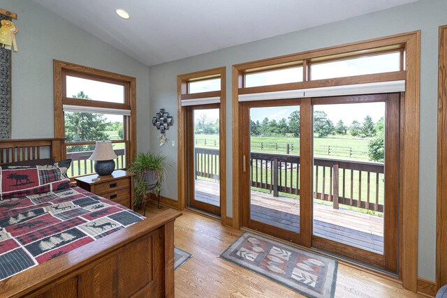 W340S2401 County Road C, Oconomowoc, WI 53066 - bedroom featuring access to outside, light wood-type flooring, recessed lighting, lofted ceiling, and baseboards