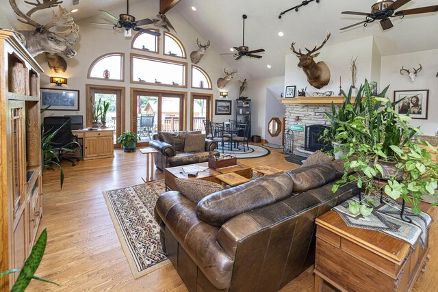 W340S2401 County Road C, Oconomowoc, WI 53066 - living area with a ceiling fan, a fireplace, beam ceiling, light wood-style flooring, and high vaulted ceiling